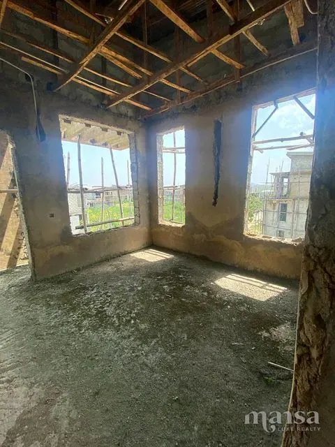 A corner room on the top floor with three window openings looking over the estate