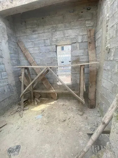 An unfinished room with a doorway and bamboo props