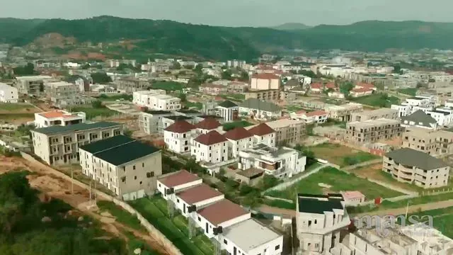 Aerial view over Katampe Extension, Abuja, with houses, roads and green hills in the distance