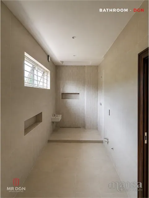 A bathroom with a walk-in shower and recessed wall niches in the Katampe Extension house, before completion