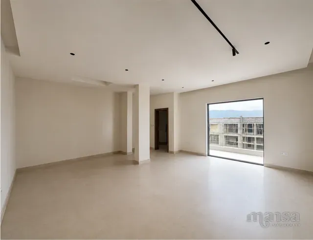 A bedroom with a full-height sliding door in the Katampe Extension house, before completion