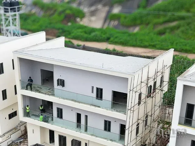 Aerial photograph of the Katampe Extension house under construction in Abuja, with scaffolding still in place