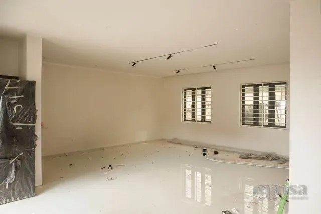 An interior room of the Katampe Extension house during finishing, with a door wrapped for protection