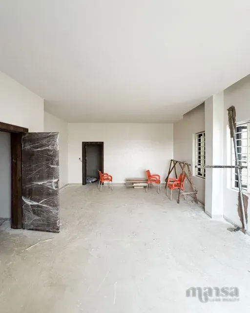 A large interior room of the Katampe Extension house during construction before the floor finish was laid