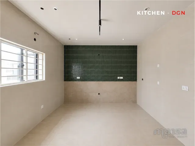The kitchen's dark green tiled wall in the Katampe Extension house, before completion